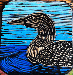 Woodcut Coaster Featured a Loon Swimming